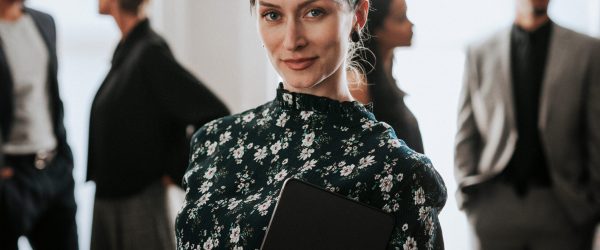 Confident businesswoman standing with a digital tablet